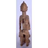AN AFRICAN CARVED WOODEN FERTILITY FIGURE, formed as a seated female with child upon her lap. 46 cm