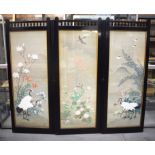 A 19TH CENTURY JAPANESE MEIJI PERIOD THREE PANEL SILKWORK SCREEN painted with birds within a landsc