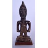 A NIGERIAN YORUBA CARVED WOODEN STATUE, formed as a standing figure. 32 cm high.