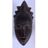 A GABONESE WOODEN PUNU MASK, carved with diamond shaped scarification marks. 33 cm x 14.5 cm.