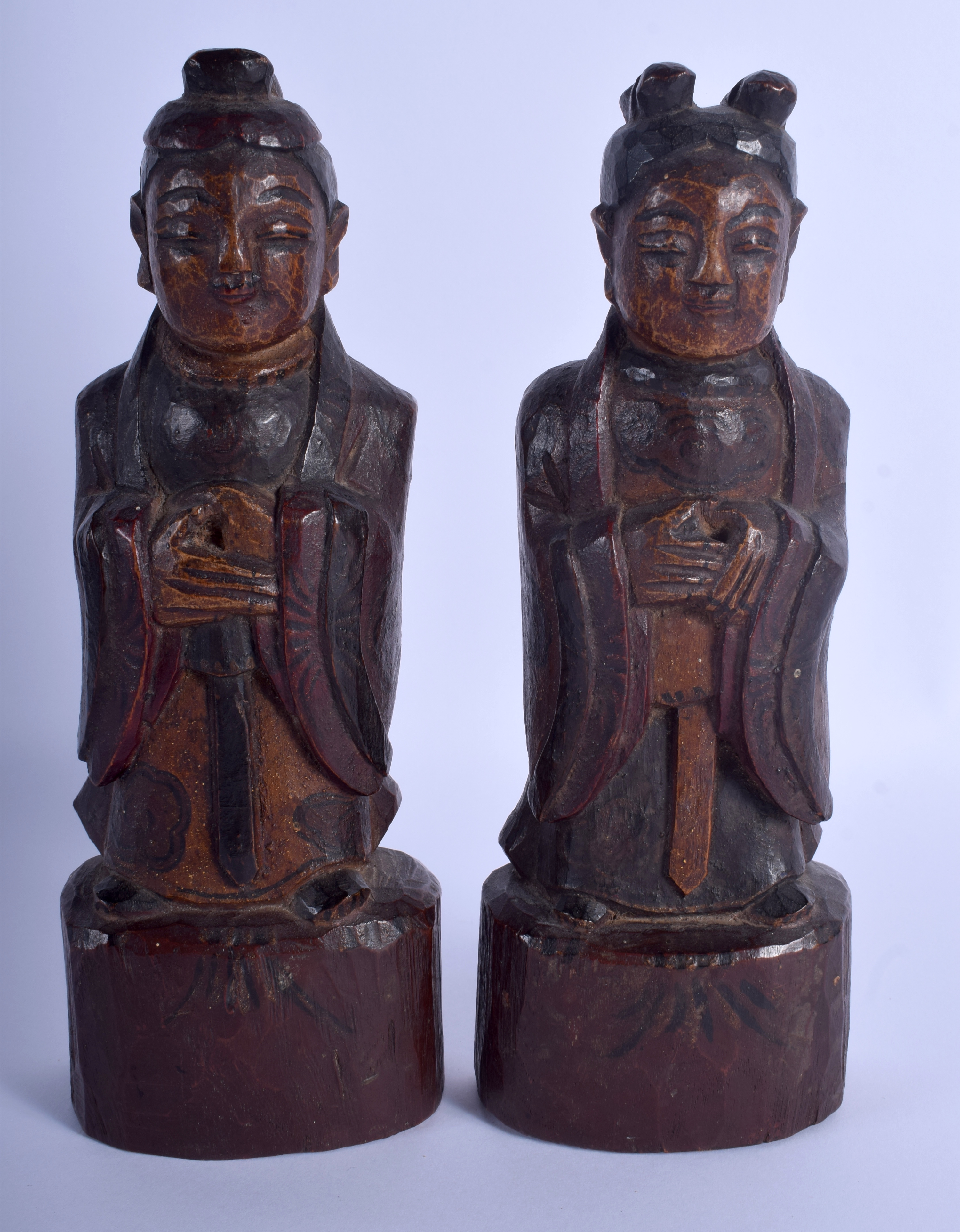 A PAIR OF 19TH CENTURY KOREAN JOSEON DYNASTY CARVED WOOD BUDDHAS modelled upon wooden plinths. 23 c