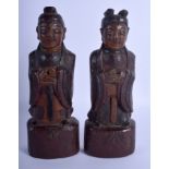 A PAIR OF 19TH CENTURY KOREAN JOSEON DYNASTY CARVED WOOD BUDDHAS modelled upon wooden plinths. 23 c