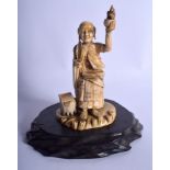 A 19TH CENTURY JAPANESE MEIJI PERIOD CARVED IVORY BUDDHISTIC GOD modelled holding aloft a bonzai tr