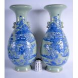 A LARGE PAIR OF 19TH CENTURY CHINESE CELADON BLUE AND WHITE VASES Late Qing, painted with figures i