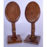 A PAIR OF ANTIQUE ADJUSTABLE SHOE STANDS. 25 cm high when not extended.