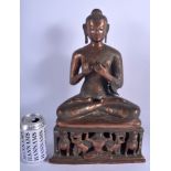 A 19TH CENTURY INDIAN TIBETAN NEPALESE COPPER ALLOY FIGURE OF A BUDDHA modelled seated over Buddhis