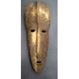 A MALIAN DOGON WOODEN MASK, formed with an elongated face. 78 cm x 30 cm.