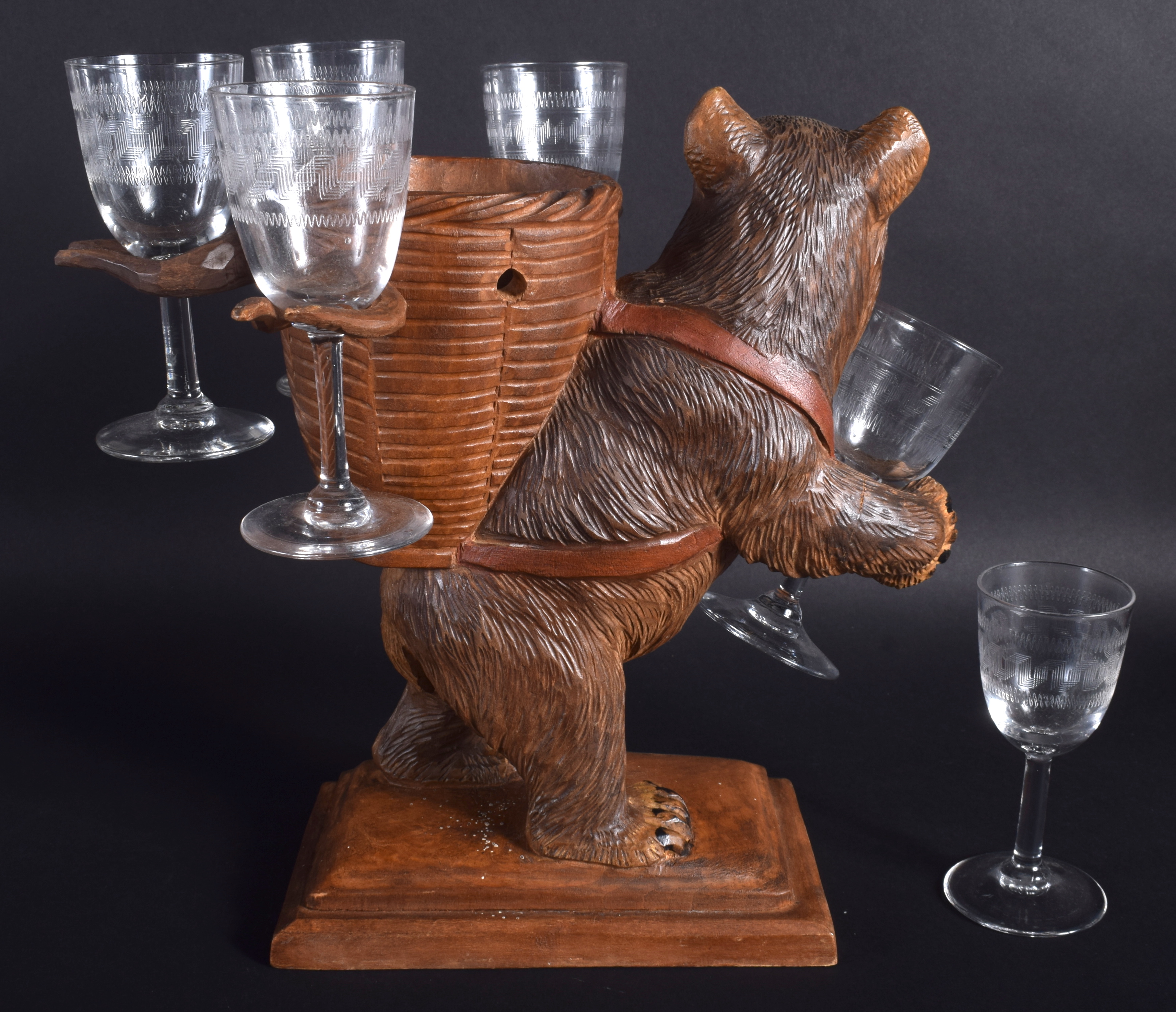 A 19TH CENTURY BAVARIAN BLACK FOREST ROAMING BEAR modelled holding six glasses. 28 cm x 32 cm. - Image 2 of 2