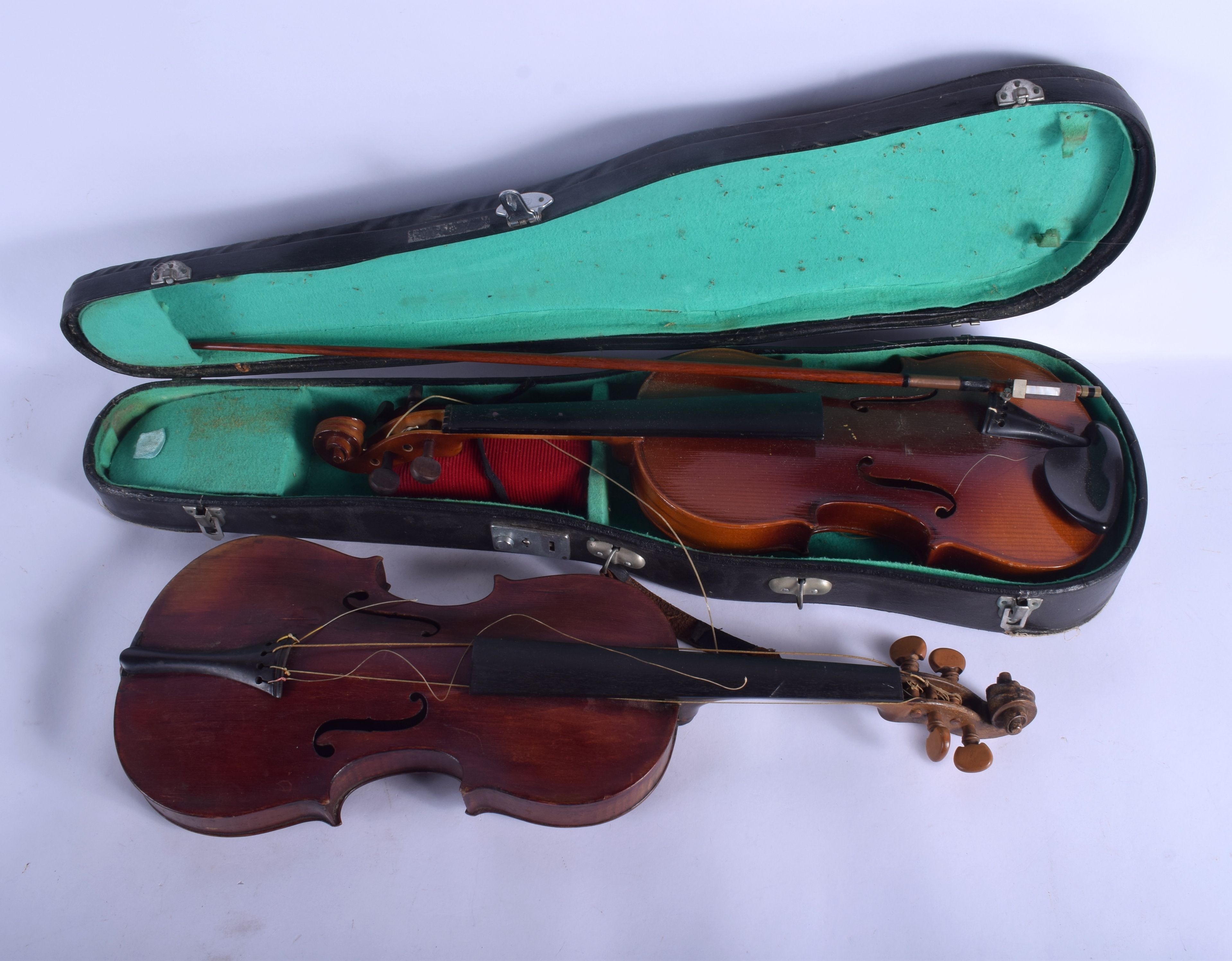 A VINTAGE TWO PIECE BACK VIOLIN together with another within a case. 64 cm long. (3)