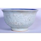 A CHINESE PALE GLAZED PORCELAIN BOWL BEARING QIANLONG MARKS, decorated in relief with fish and pre