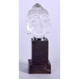 A CARVED ROCK CRYSTAL BUDDHA HEAD, fitted upon a bronze stand. 6.25 cm high.