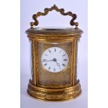A GOOD 19TH CENTURY FRENCH OVAL BRASS CARRIAGE CLOCK engraved with foliage and vines. 16 cm high in