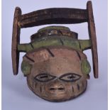 A NIGERIAN YORUBA POLYCHROMED WOODEN MASK, formed with a bird like finial. 32 cm x 30 cm.