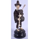 A 19TH CENTURY BAVARIAN CARVED WOOD BLACK FOREST MUSICIAN modelled playing bag pipes. 18 cm high.