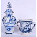 A DUTCH POTTERY VASE AND COVER, together with a twin handled cup. Largest 26 cm. (2)