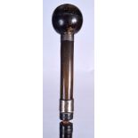 A BUFFALO HORN HANDLED WALKING CANE, formed with a spherical top. 84 cm long.