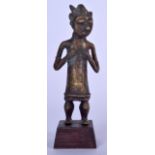 A BENIN BRONZE FIGURE OF A STANDING FEMALE, formed tweaking her breasts. 20 cm.