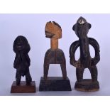 AN IVORY COAST GURO OR DAN WOODEN HEDDLE PULLEY, together with two figures. Largest 20.5 cm high. (