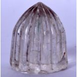 AN ISLAMIC ROCK CRYSTAL CARVING, possibly a gaming piece. 3.5 cm high.