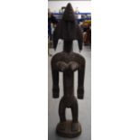 A LARGE MALIAN BAMBARA WOODEN STATUE, formed standing with copper piercings and studwork to head. 8