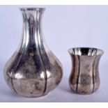 AN ANTIQUE MIDDLE EASTERN PERSIAN SILVER BOTTLE with matching beaker. 19 cm & 9 cm high. 21 oz. (2)