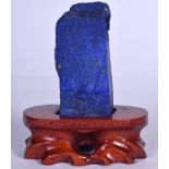 A CHINESE LAPIS LAZULI SCHOLARS ROCK, fitted to a naturalistic stand. 12.5 cm high.