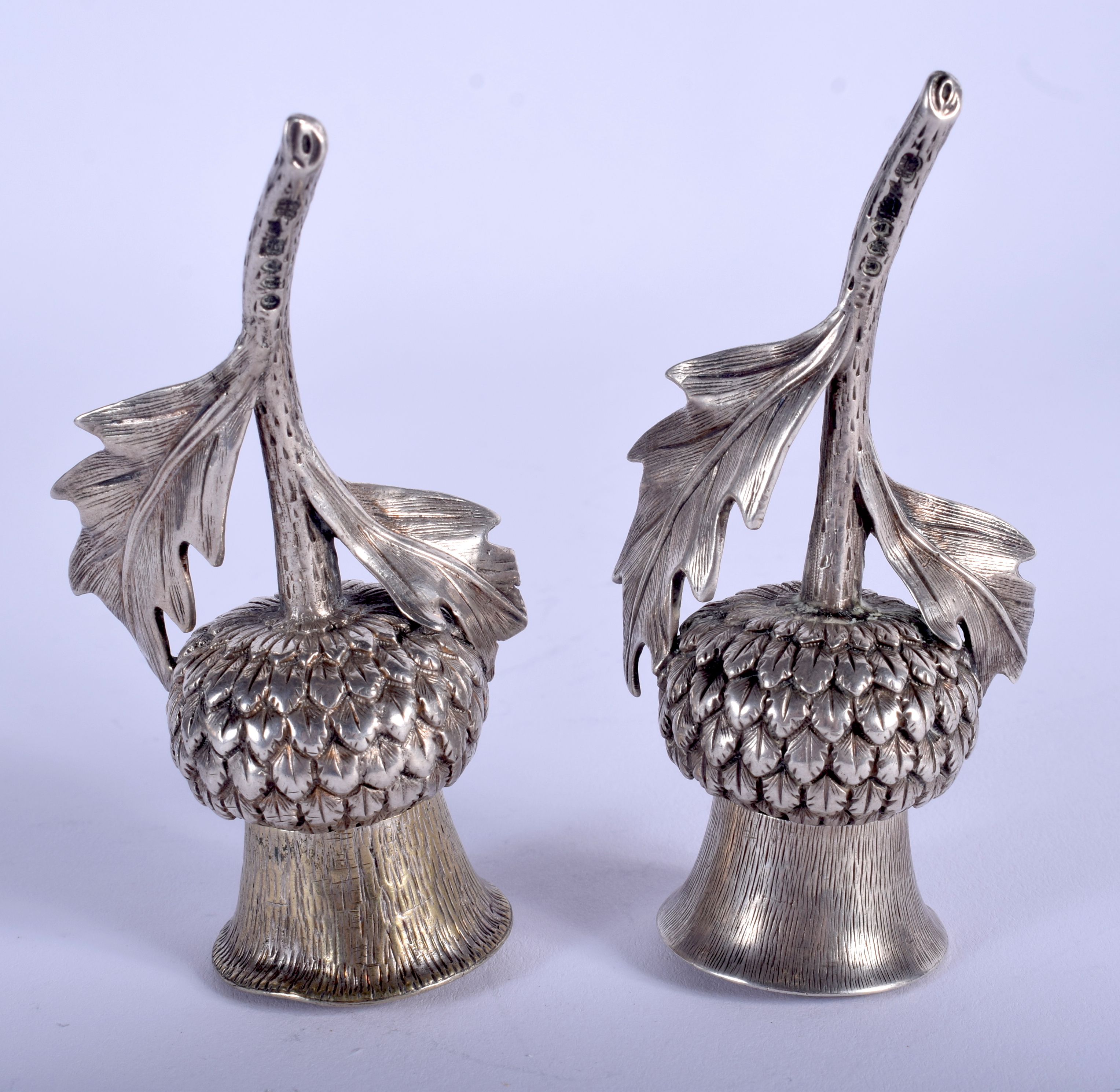 A PAIR OF VICTORIAN SILVER THISTLE DESK SANDERS. 9 cm long.