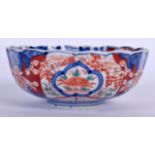 A JAPANESE MEIJI PERIOD PORCELAIN BOWL, lobed in form and painted with foliage. 17 cm wide.
