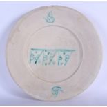A LARGE 12TH/13TH CENTURY SAFAVID TIMURID POTTERY DISH Persia, painted with green scripture and mot