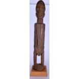 A WEST AFRICAN CARVED WOODEN STATUE, formed standing with an elongated body. 67 cm high.