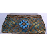 A TURKISH TURQUOISE COLOURED BEAD PURSE, decorated with brass plaques. 25 cm wide.