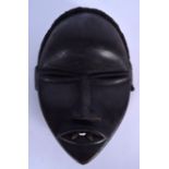 A WEST AFRICAN WOODEN DAN MASK, formed with two carved fangs. 31 cm x 14 cm
