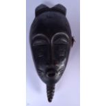 AN IVORY COAST WOODEN BAULE MASK, carved with a beard and horns. 33.5 cm x 15 cm.