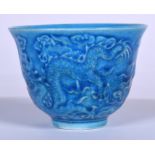 A CHINESE BLUE GLAZED PORCELAIN TEA BOWL, decorated with a dragon amongst the clouds, 20th century.