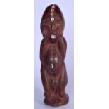 A CONGOLESE LEGA WOODEN FIGURE, inset with shell decoration. 42 cm high.