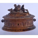 A 19TH CENTURY BLACK FOREST BAVARIAN CARVED WOOD CASKET with bird finial. 17 cm wide.