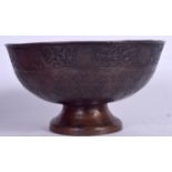 A 19TH CENTURY ISLAMIC BRONZE PEDESTAL BOWL, decorated with script. 21.5 cm wide.