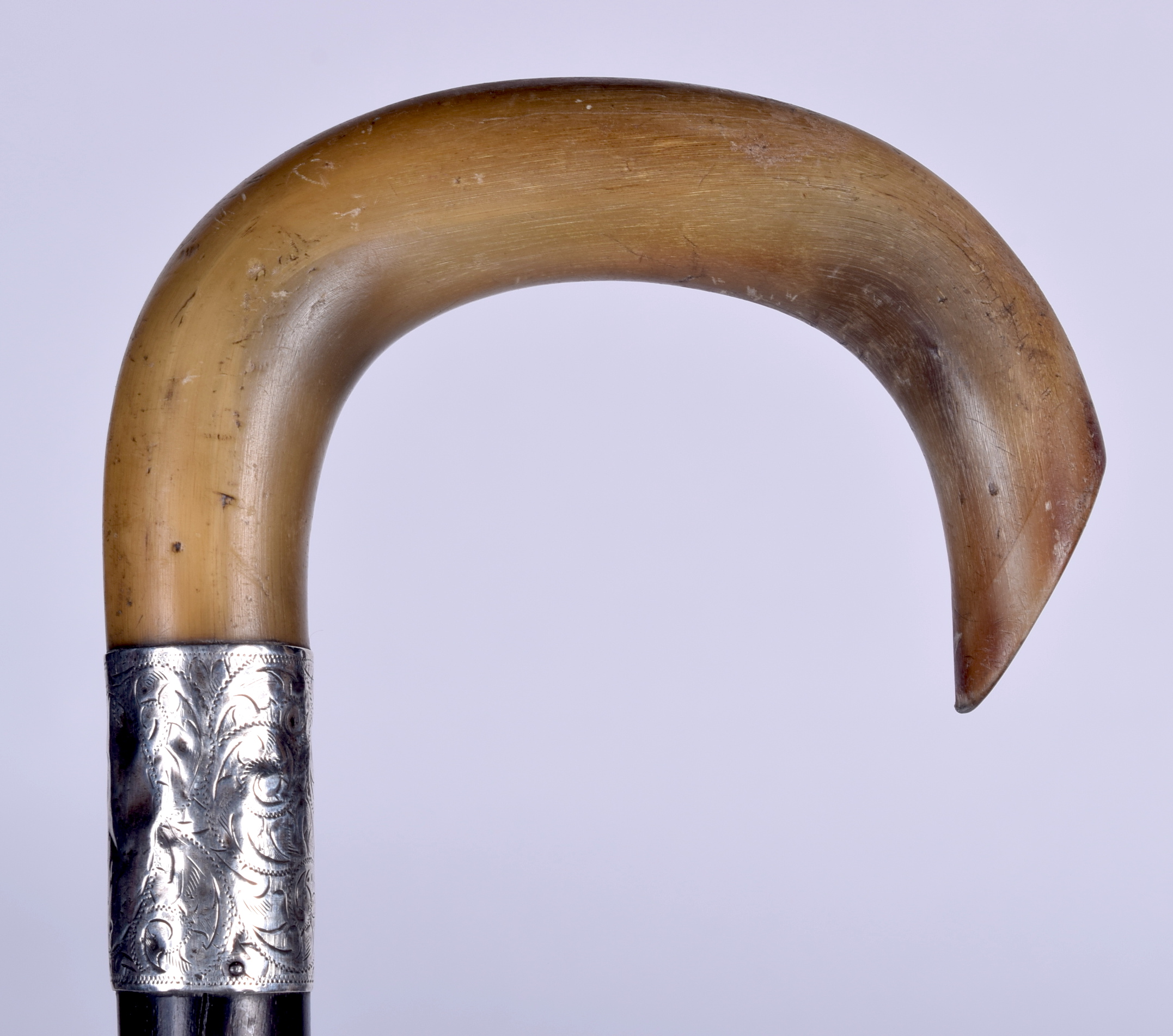 A 19TH CENTURY RHINOCEROS HORN HANDLED WALKING STICK, formed with a silver collar and lignum vitae