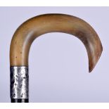 A 19TH CENTURY RHINOCEROS HORN HANDLED WALKING STICK, formed with a silver collar and lignum vitae