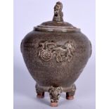 A CHINESE TRI LEGGED POTTERY CENSER, formed with foo dog finial. 20 cm high.