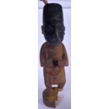 A NIGERIAN YORUBA CARVED WOODEN STATUE, formed as a standing male with an elongated head. 57 cm hig