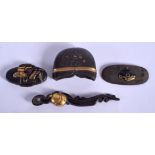 FOUR 19TH CENTURY JAPANESE MEIJI PERIOD SWORD FITTINGS in various forms and sizes. (4)