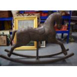 AN ANTIQUE INDIAN COPPER PANEL WOODEN ROCKING HORSE, decorated with panels of foliage. 94 cm x 133