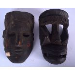TWO AFRICAN CARVED WOODEN MASKS, varying form. Largest 23 cm long. (2)