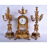 A LARGE EARLY 19TH CENTURY FRENCH ORMOLU CLOCK GARNITURE overlaid with mask heads and wreaths. Cloc