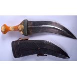 AN ANTIQUE OMANI GOLD INLAID AMBER JAMBIYA DAGGER decorated with coinage. 31 cm wide.