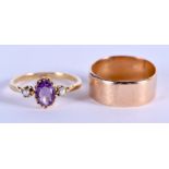 A 15CT GOLD WEDDING BAND together with a gold and amethyst ring. 4 grams 15ct, 2.5 grams 9 ct. (2)