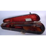 A CASED VIOLIN, together with associated bow. 59 cm long.