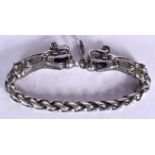 A CHINESE WHITE METAL BRACELET, formed as opposing dragon heads. 22 cm long.