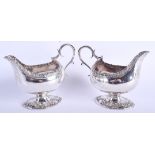 A PAIR OF ARMORIAL GEORGE III SILVER SAUCE BOATS. London 1765. 20.5 oz. 17 cm x 13 cm.